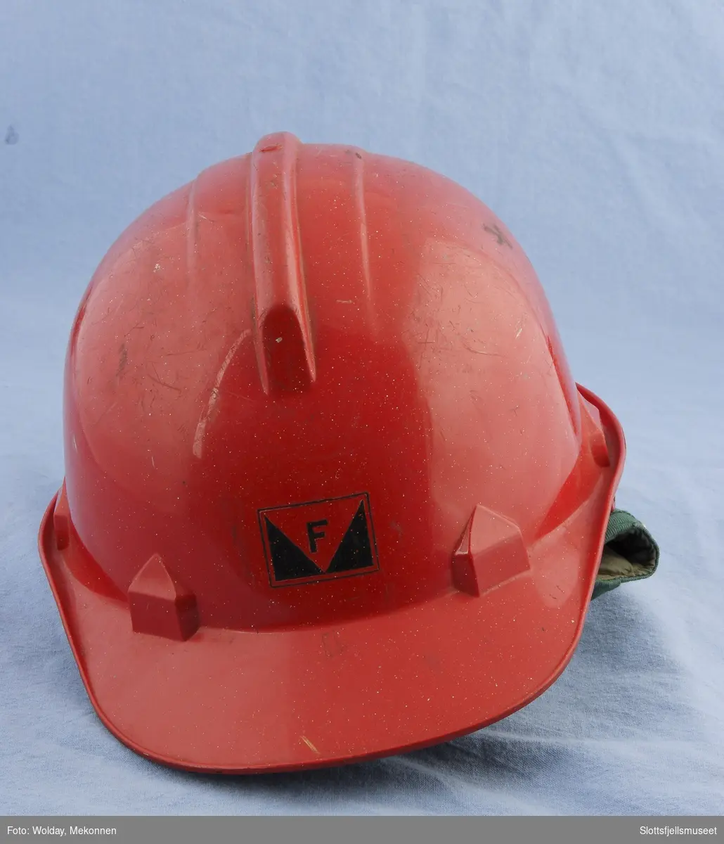 Rød hjelm med Framnæs-logo foran. Glassfiber, plast, skai, kunststoffreimer.