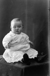 Studioportrett av et lite barn i helfigur.