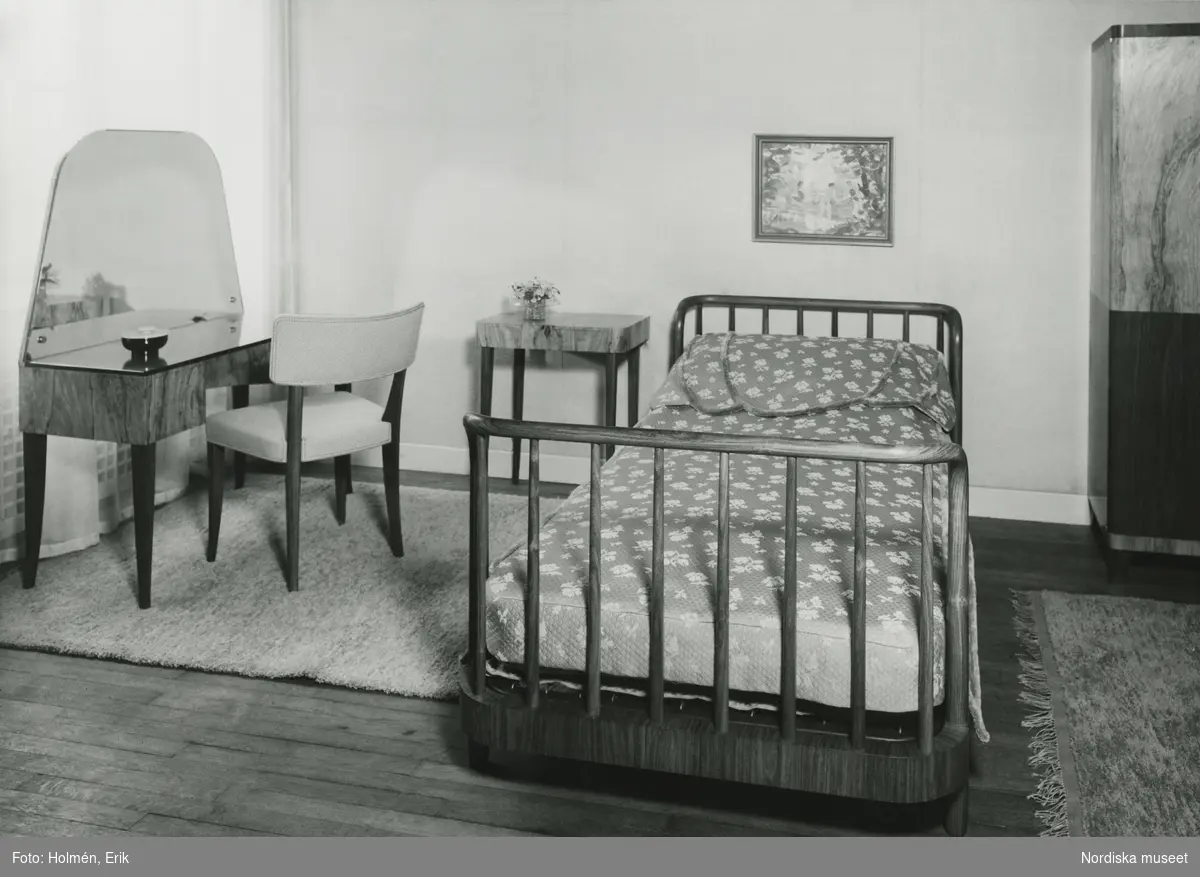 Möbelutställning på Nordiska Kompaniet, "Vackra möbler" maj 1937. Sovrumsmöblemang formgivet av Axel Einar Hjort. Säng, sängbord, toalettbord, stol.