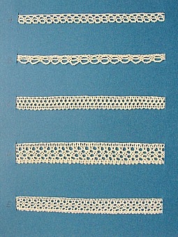 Blått kartongark med fem prover på knypplad skånsk spets från östra Göinge härad. Vid varje prov står en stor bokstav.
A. 13 x 0,8 cm
B. 13 x 0,7 cm
C. 13 x 1,2 cm
D. 13 x 1,8 cm
E. 13 x 1,3 cm