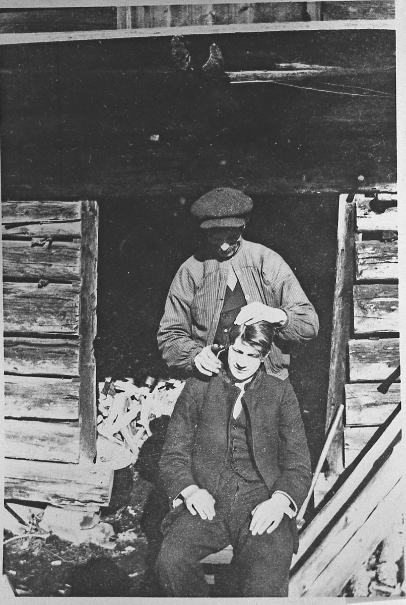 Petter Dalen klipper håret til Thorleif Eken. På Dalen, ca. 1917-18.