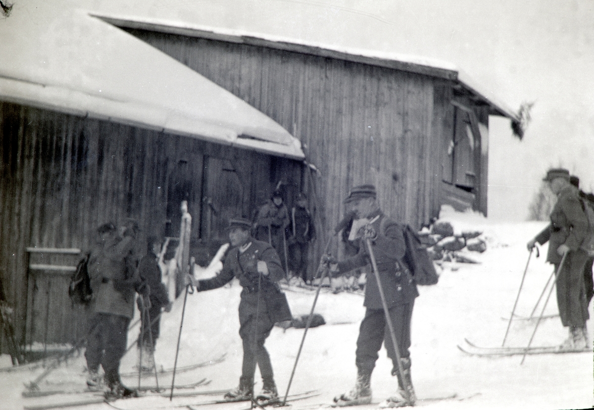 Militærøvelse i Romedal 1937. Vinterøvelse. Kronprins Olav var tilstede under øvelsen. Vinter, snø, ski, militæret. Ved låven i Haukåsen, Romedal.