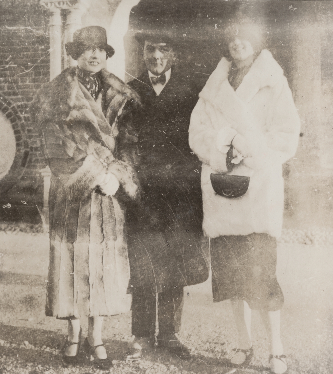 Grupporträtt. Från vänster Anna Linderstam, militären Nils Kindberg samt okänd kvinna utanför byggnad i Strängnäs 1925.

Text i album: "Jan. 1925. Strängnäs. Annika. NK. Muffsie."