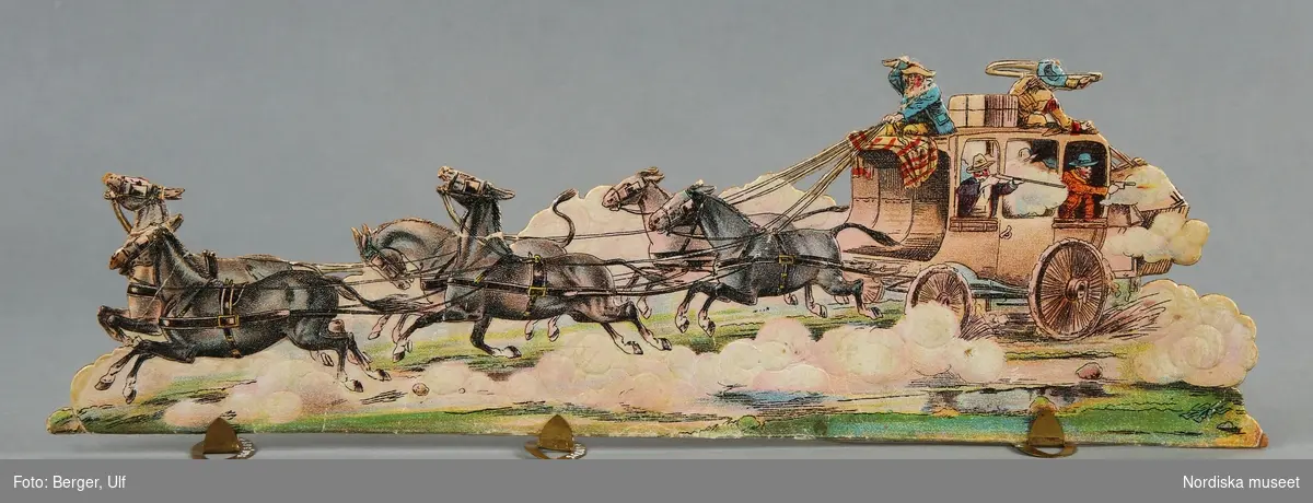 Pappersleksak i flera delar (18 lösa bitar enligt katalogkort) föreställande kamp mellan indianer och cowboys i vilda västern.