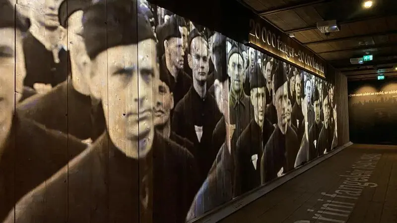 Photo exhibition at Grinimuseet. Projection of prisoners on wall.