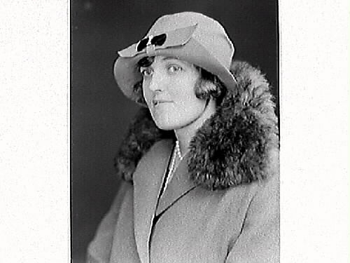 Kvinnoporträtt av fröken Bremberg, iförd hatt och kappa med pälsbräm.