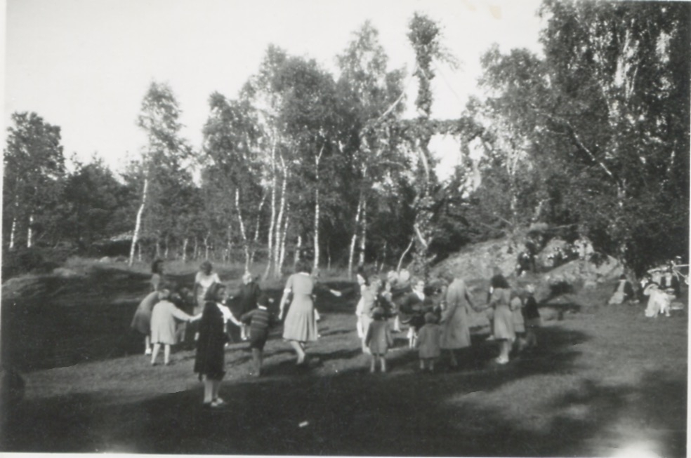 Människor dansar kring midsommarstången, troligtvis på Ekansås 1940-tal. Bilden kommer från ett album från "Nygård" Kållered stom.