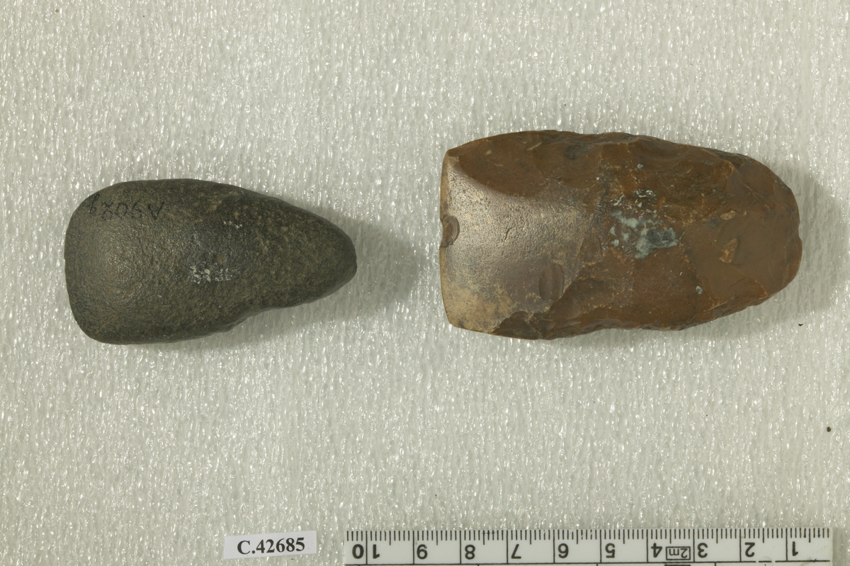 Two Stone axes of grinded granite and flint, edged. Compare: G. Caton-Thompson - E. W. Gardner, The Desert Fayum (1934) pl. VIII;  IX;  XXII;  XXIII.
