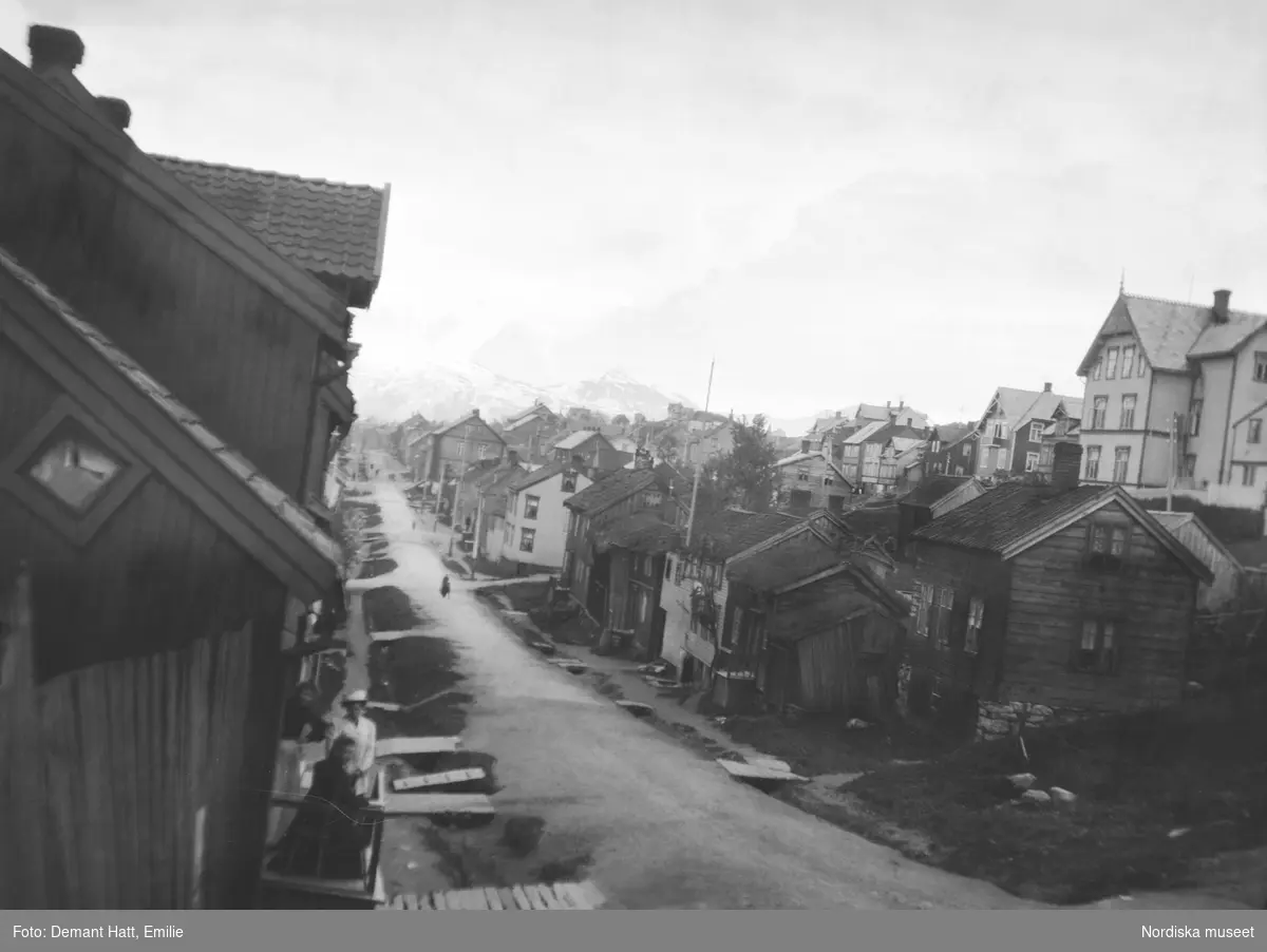 Stadsbild från Tromsø i Norge. Låga trähus kantar gatorna.Bilden ingår i en serie fotografier tagna av Emilie Demant Hatt i Sapmi mellan åren 1907 och 1916.