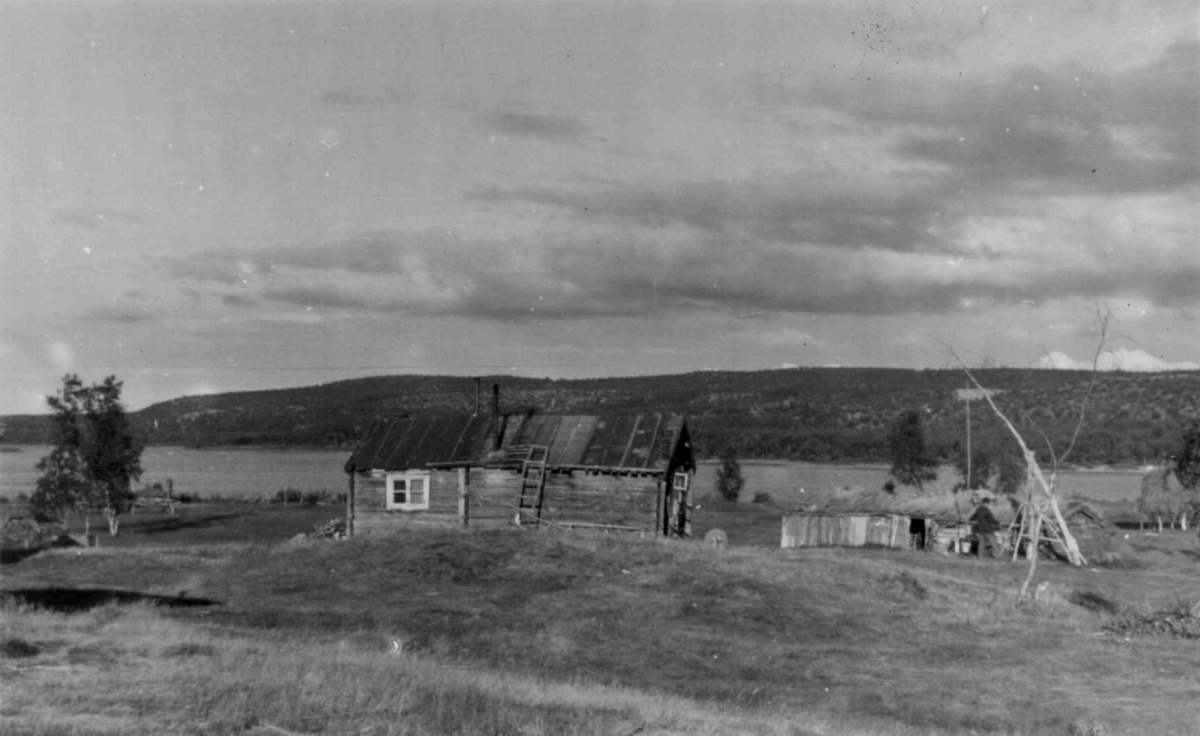 Våningshuset, fjøset og brønnen på gården til J. Bongo. Hemmugiedde, Kautokeino, Finnmark, foto 1953. Huset står nå på bygdetunet i Kautokeino. 