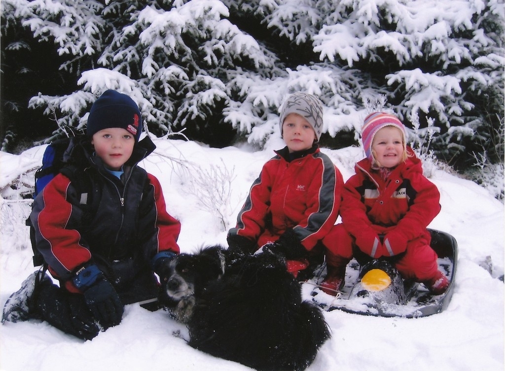 Olve, Gabriel og Oda leikar i snøen, alle med etternamn Aarrestad Skrudland. Hunden er også med.