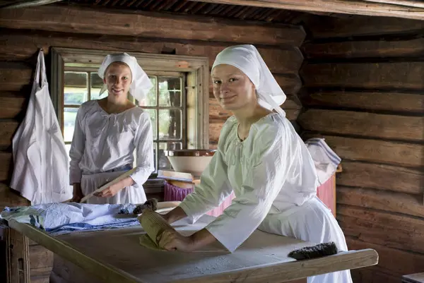 Two women baking lefse