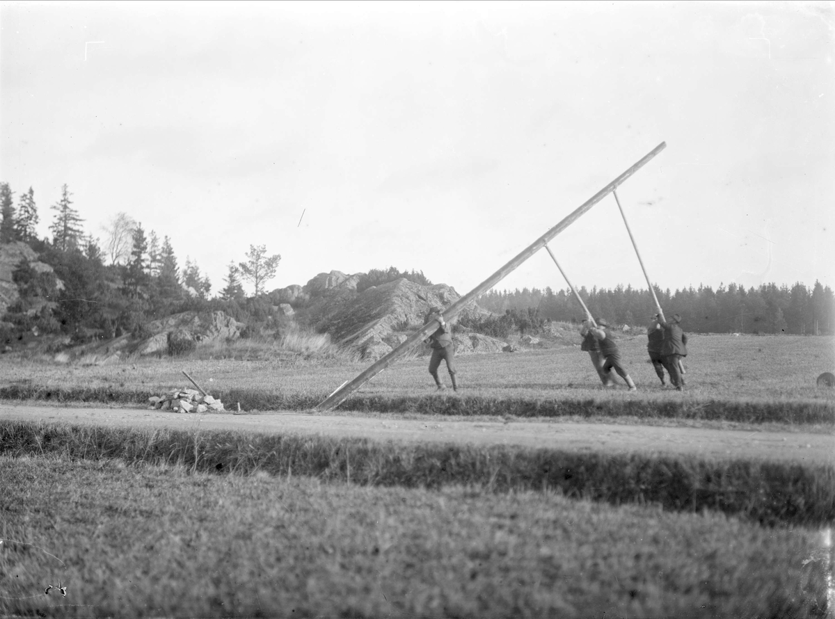 Stolplaget reser elstolpe vid vägkant - "stolpen går i höjden utan större ansträngning", Sävasta, Altuna socken, Uppland 1920