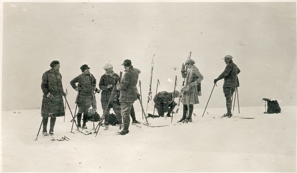 En gruppe menn og kvinner i snøkov/snøvær på skitur.
