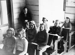 Personer, klær, skolepulter.