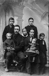 Familie, foreldre med seks barn. Foto i atelier.