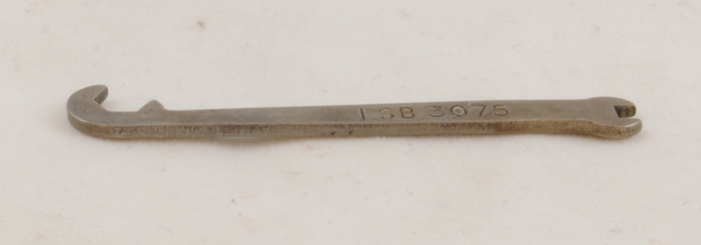 Fast nyckel med verktyg i båda ändar. I ena änden är det en nyckel för sexkantig mutter och i andra änden en för fyrkantig. På skaftet står det "LSB 3075".