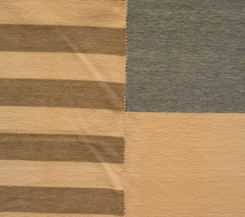 Ett mjukt och kraftigt överkast i kypert. Vävt med bomullsgarn i varpen och velourgarn i inslaget. Överkastet är vävt i tre delar som är hopsydda. Sidstyckena är grå och vitrandiga, mitten stycket är blå, vit, gul, rosa i kvadratiska rutor.

Överkastet är märkt med R31:1 på ett vitt bomullsband. En fyrkantig vit klisterlapp med texten TRIO är fastklistrad i ena änden.

Överkast med modellnamn Trio är formgivet av Ann-Mari Nilsson och tillverkat av Länshemslöjden Skaraborg. Det finns med  på sidan 72-73 i vävboken Inredningsvävar av Ann-Mari Nilsson i samarbete med Länshemslöjden Skaraborg från 1987, ICA Bokförlag. Se även inv.nr. 0001-0030,0032-0040.