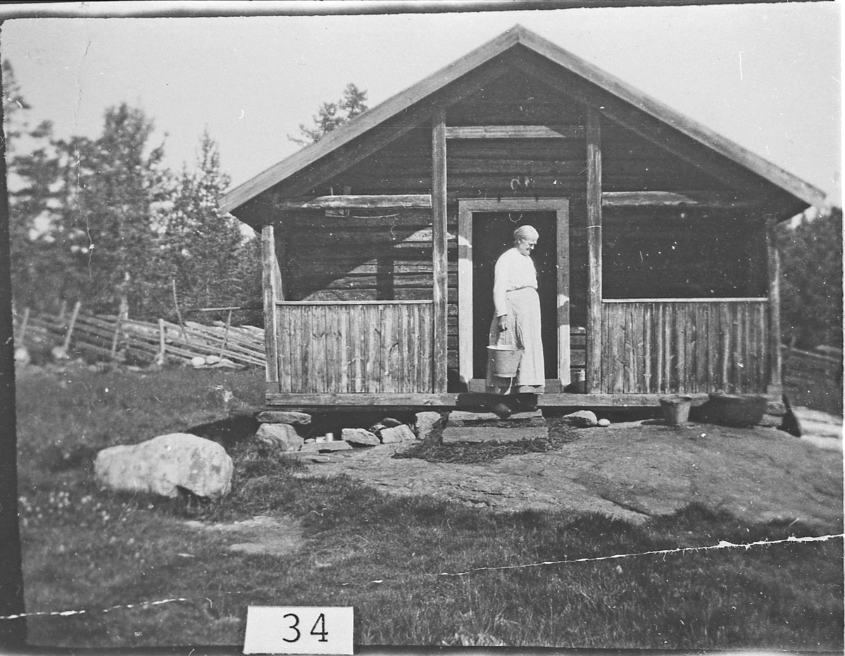 Viksetra i Sigdal. Kjersti Vik stående på trappa. Ca. 1924-25.