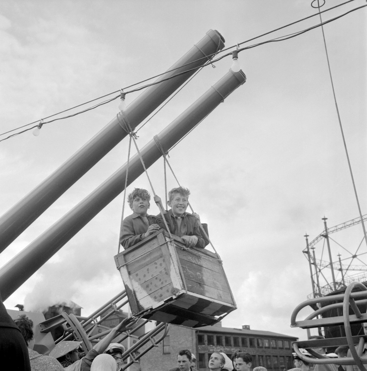 Kanonrören på jagaren HMS Östergötland tjänsgör för en dag som gungstativ. Det hände under söndagen den 18 maj 1958, då det arrangerades besöksdag vid fartygets besök i Norrköpings inre hamn. Fartyget hade kort före levererats till Marinen och var på färd från Götaverken i Göteborg till sin bestämmelseort.