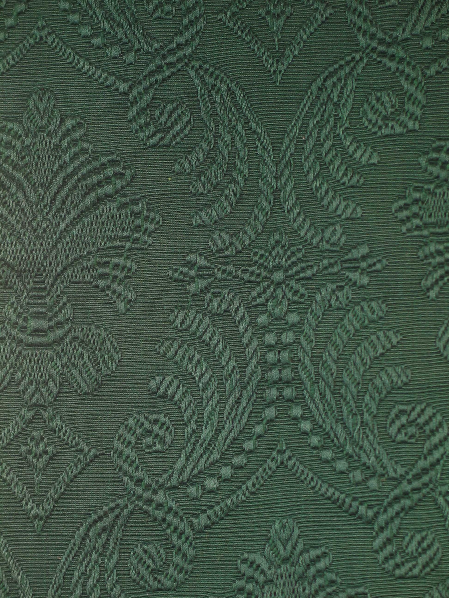 Mørk grønt jacquardvevd portierestoff . Mønstring ved flottering av mercerisert bomull på ripsbunn.
Motiv: Palmett i oval form, omgitt av bladverk; stilisert. Mønsterets rapport er høyden 37 cm, i bredden 20 cm. 