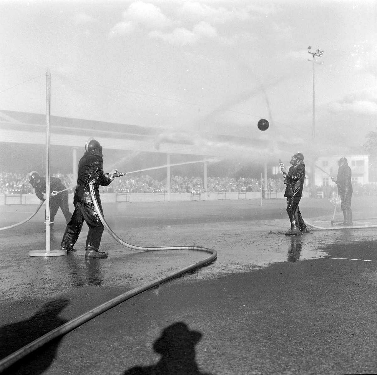 Brannmannsdagen 1958. Brannmenn spiller ball med vannslanger