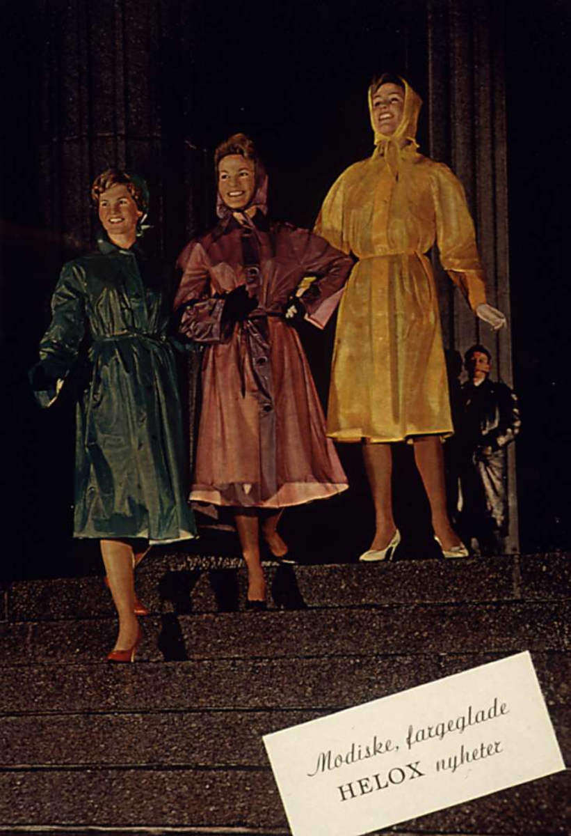 Reklame, tre damer i kulørte regnfrakker, mann i bakgrunnen, på Universitetets trapp.