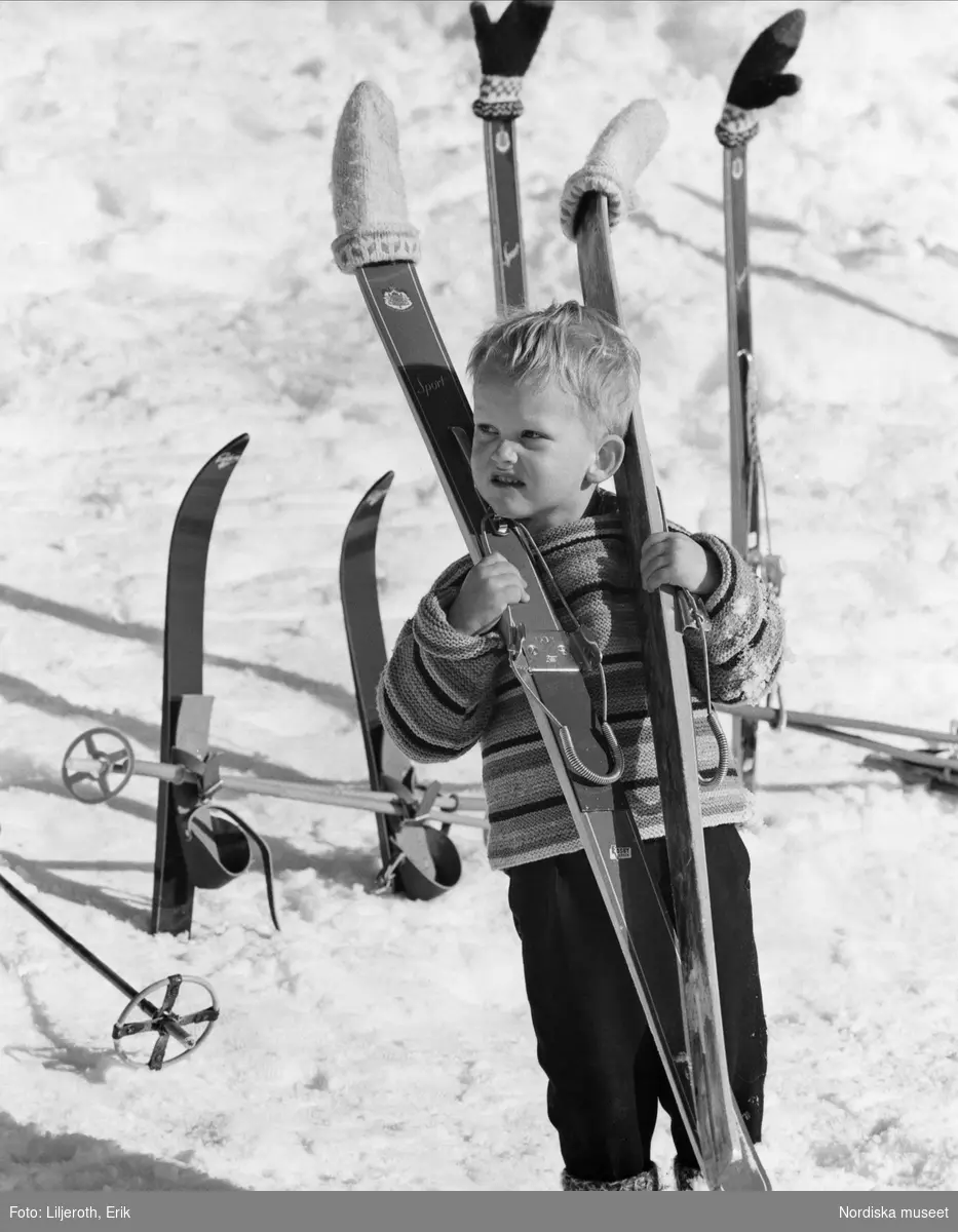 "Några vinterglimtar av natur och bebyggelse i Sijantrakten." Liten pojke med skidor.