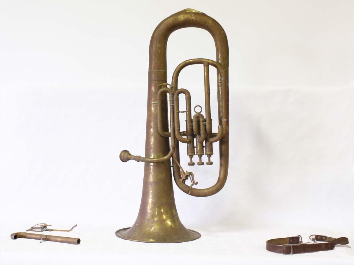 Euphonium. Blåseinstrument med munnstykke og tre ventiler på toppen, likner en liten tuba i fasongen.