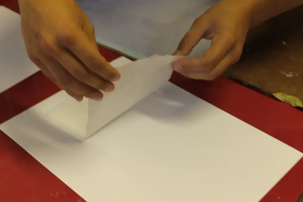 The paper is then placed on felt