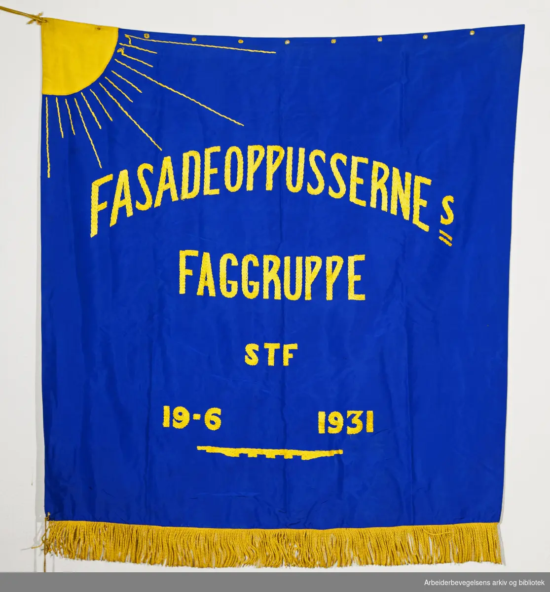 Fasadeoppussernes Faggruppe (Forside). Fanetekst: Fasadeoppussernes Faggruppe STF 19. 6. 1931