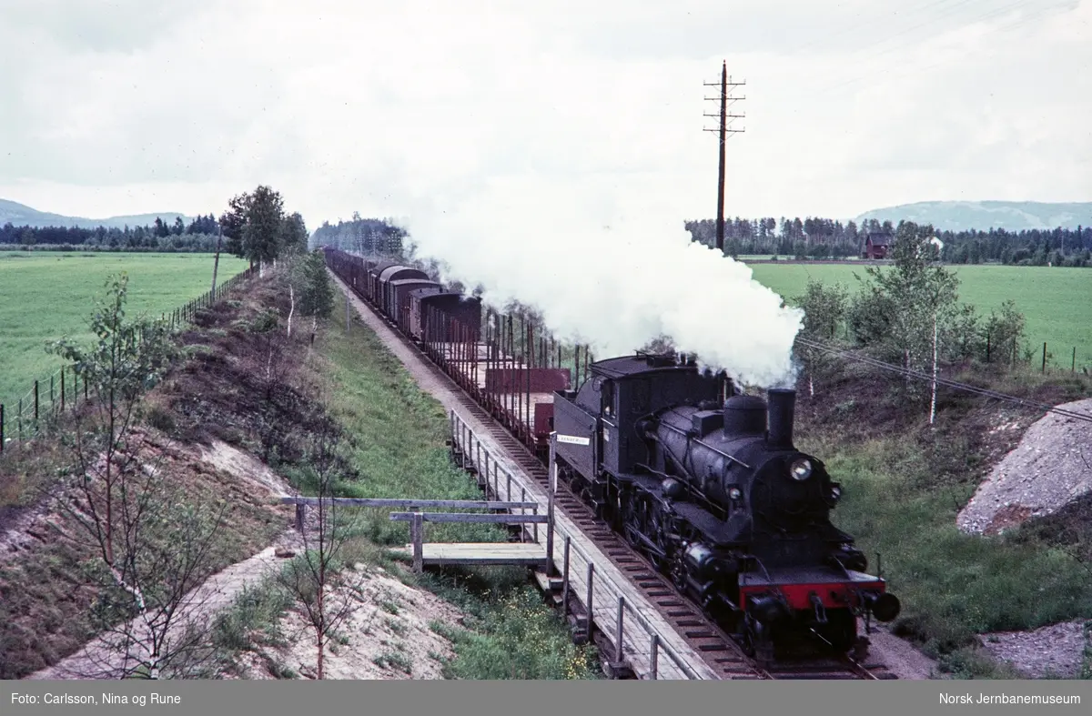 Damplok type 27a med nordgående godstog passerer Vangerud holdeplass