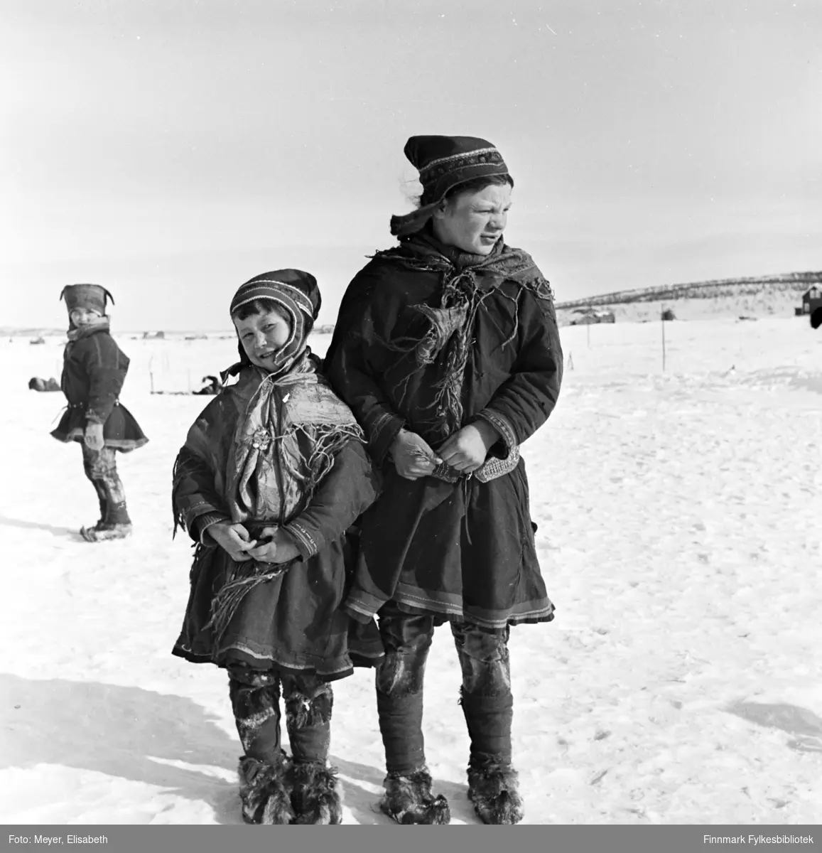 Til venstre står Berit Nilsdatter Logje. Jenta til høyre er ukjent. Fotografert i Kautokeino påsketider 1940.