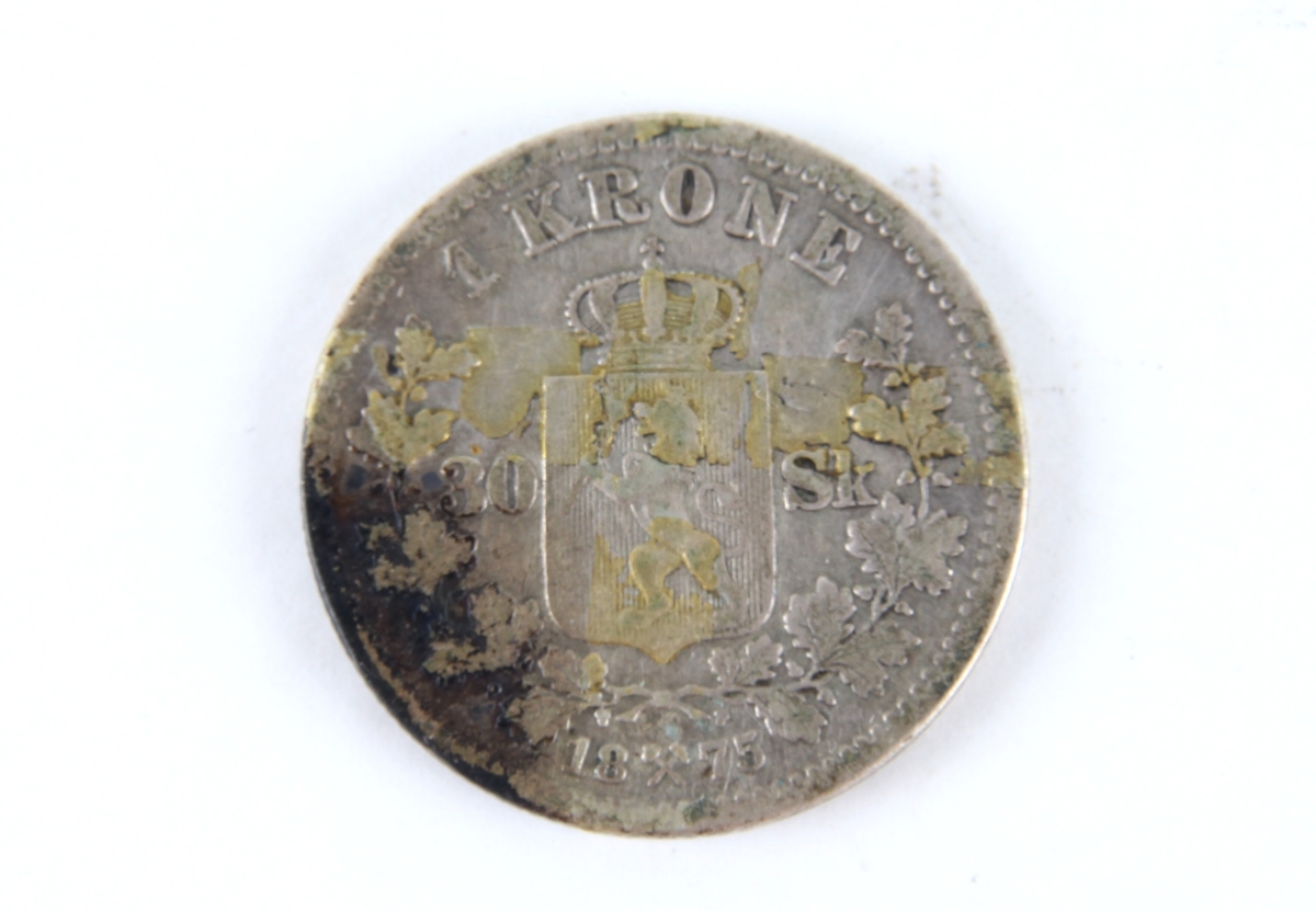 To svensk/norsk en kroner fra ulike årstall Den ene fra 1875, den andre fra 1877.