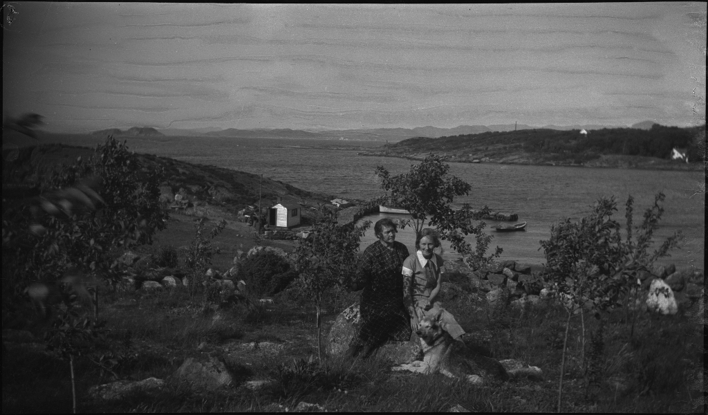 Familien Kamsrud på Tunsøy. Det er bilder av familien ved båten, av Annie Kamsrud og moren, Bertrand Kamsrud (i hvite klær) og to gutter til og hundene deres.