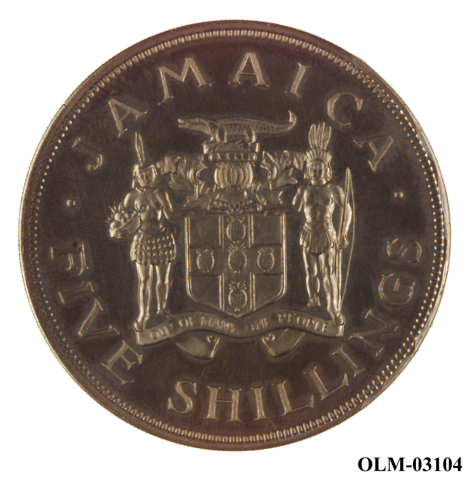 Sølvmynt med en kjede langs kanten, en krone øverst og tekst i midten. På baksiden en kvinne med fruktkurv og en mann med bue, mellom dem et våpenskjold med en krokodille øverst. Mynten ligger i en eske.