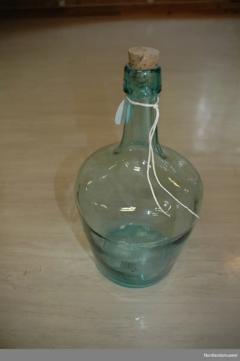 Flaska er på ca to liter. Grønnlig i fargen. Luftbobler i glasset. Kork