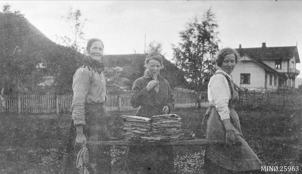 Flatbrødbakst. Kvinner. Siri Andersdatter, Olga Høye, Ukjent. Midt-Høye med Øvre Rendal Kirkestue i bakgrunn. 