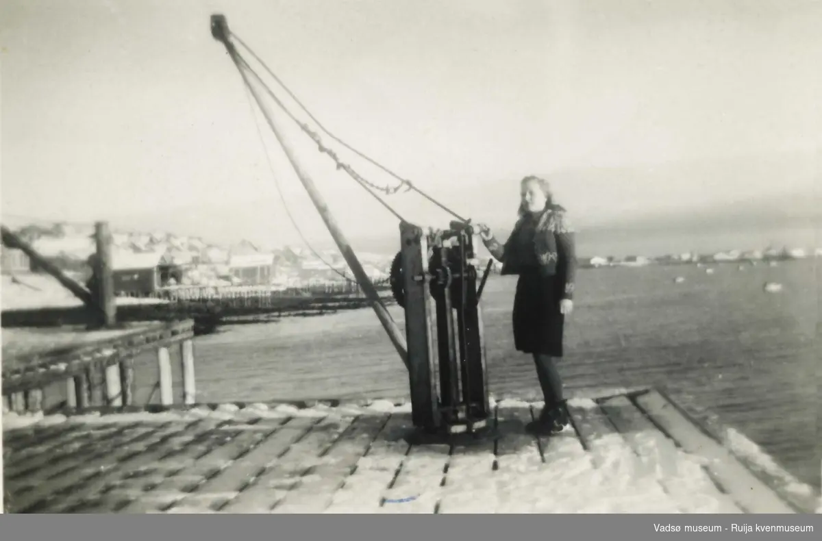 Prestelvkaia i Vadsø. Ukjent dame foran kran, 1948-49.
