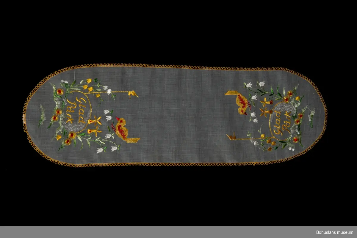 Påskduk med motiv med kycklingar och blommor. Text vid kortändarna  "Glad Påsk".