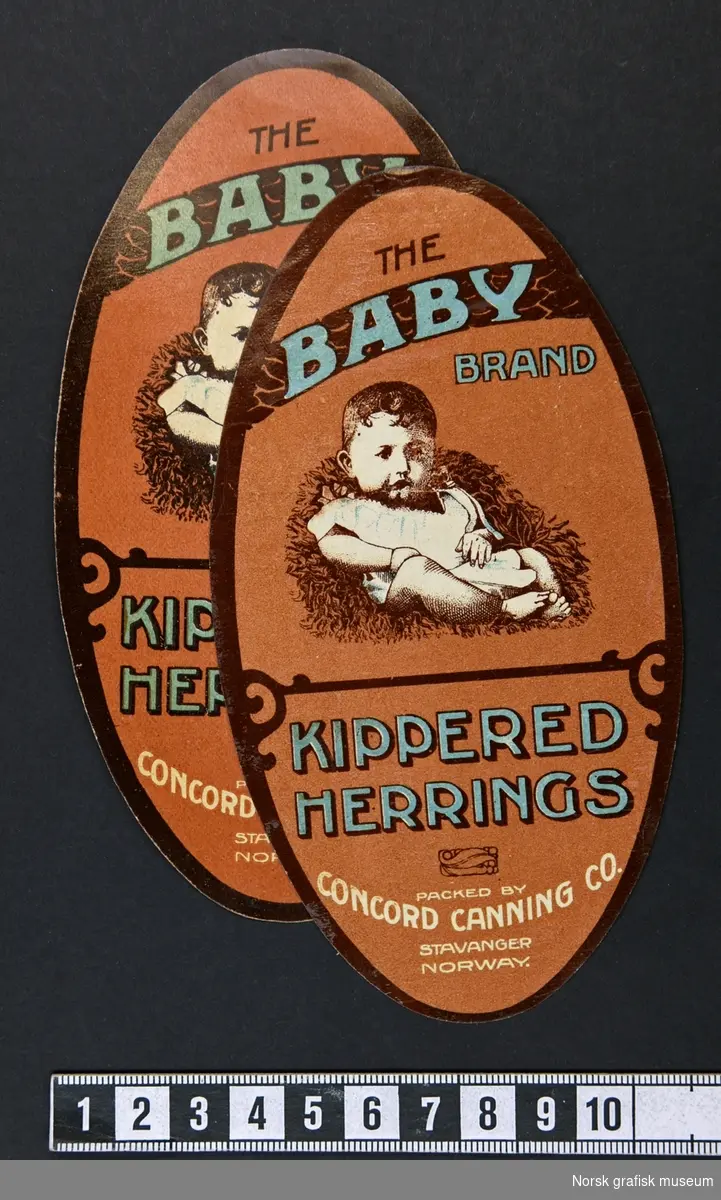 Oval etikett i brunt, med en illustrasjon av en baby over varebetegnelsen: 
"Kippered herrings"