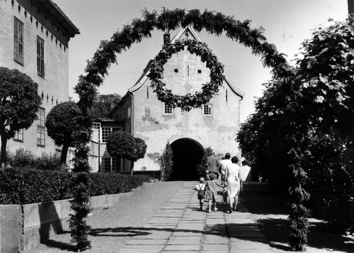 St. Hans fest på Norsk Folkemuseum i 1967. Inngangspartiet pyntet med guirlander og blomster i portal.