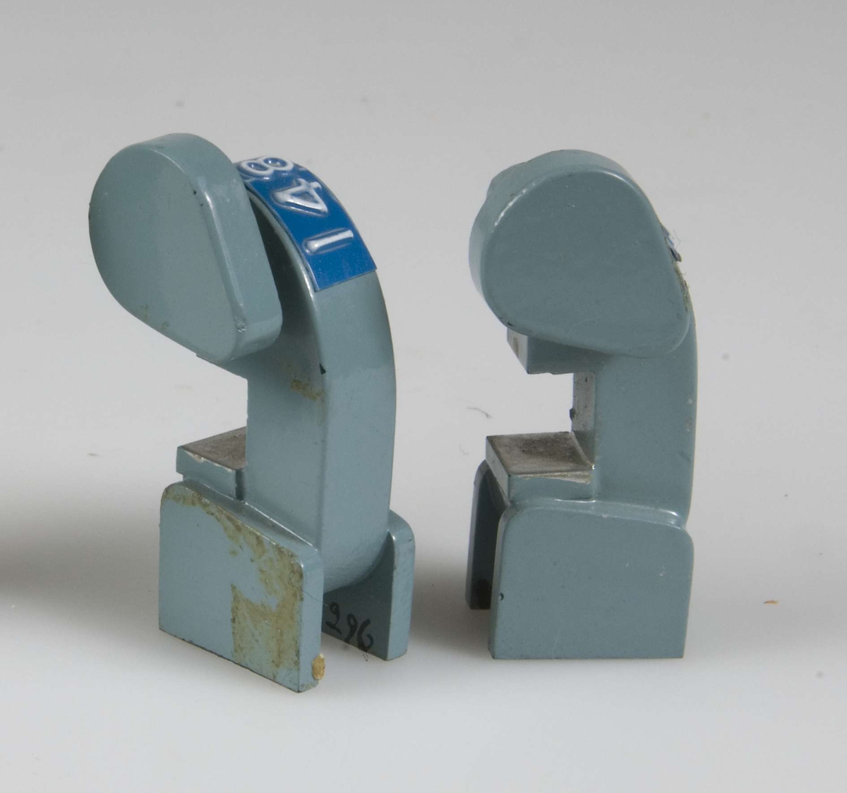 Två små maskinmodeller av trä målade ljusblå med grå detaljer. Blåvit dynamoremsa med nr 139 och 2,8 resp 148 2 H.
