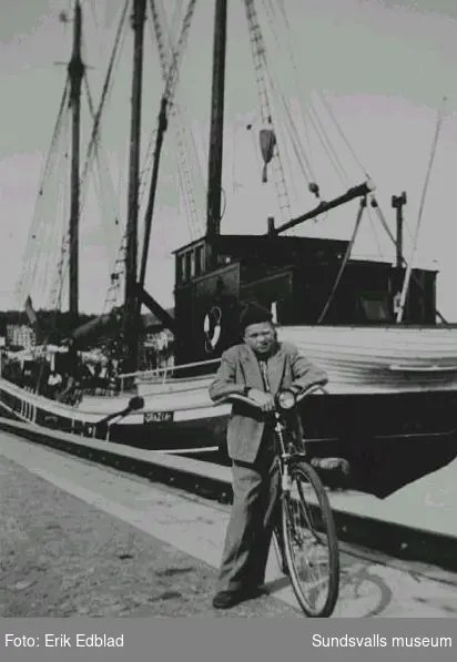 Bernt Edblad (f. 1938) med cykel på kajen i Sundsvalls hamn. I bakgrunden fartyget Grazia av Styrsö.