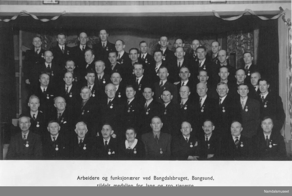 14.02.1948. Arbeidere og funksjonærer ved Bangdalsbruke, tildelt medaljen for lang og tro tjeneste 14. feb 1948. Navnene står bakpå bildet.