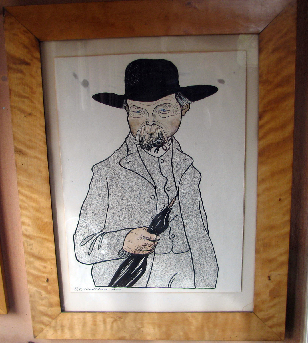 Rektangulær. Karikatur av O. Valstad, halvfigur, paraply i v. hånd, bart og skjegg, bredbremmet sort hatt 
