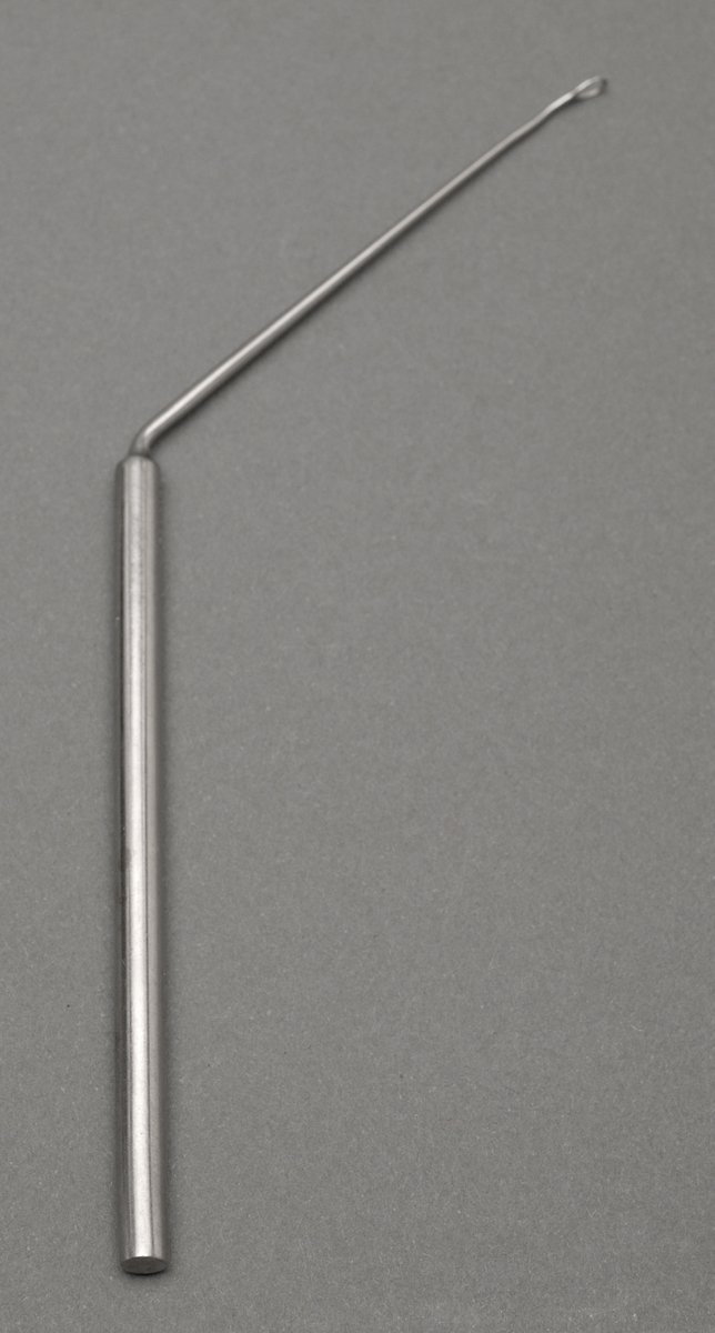 Sylindrisk metallstang, stangen avsluttes i en tynnere del som går 45° ut fra den tykkere delen. Den tynne metallstangen med en løkke, alt er av metall.