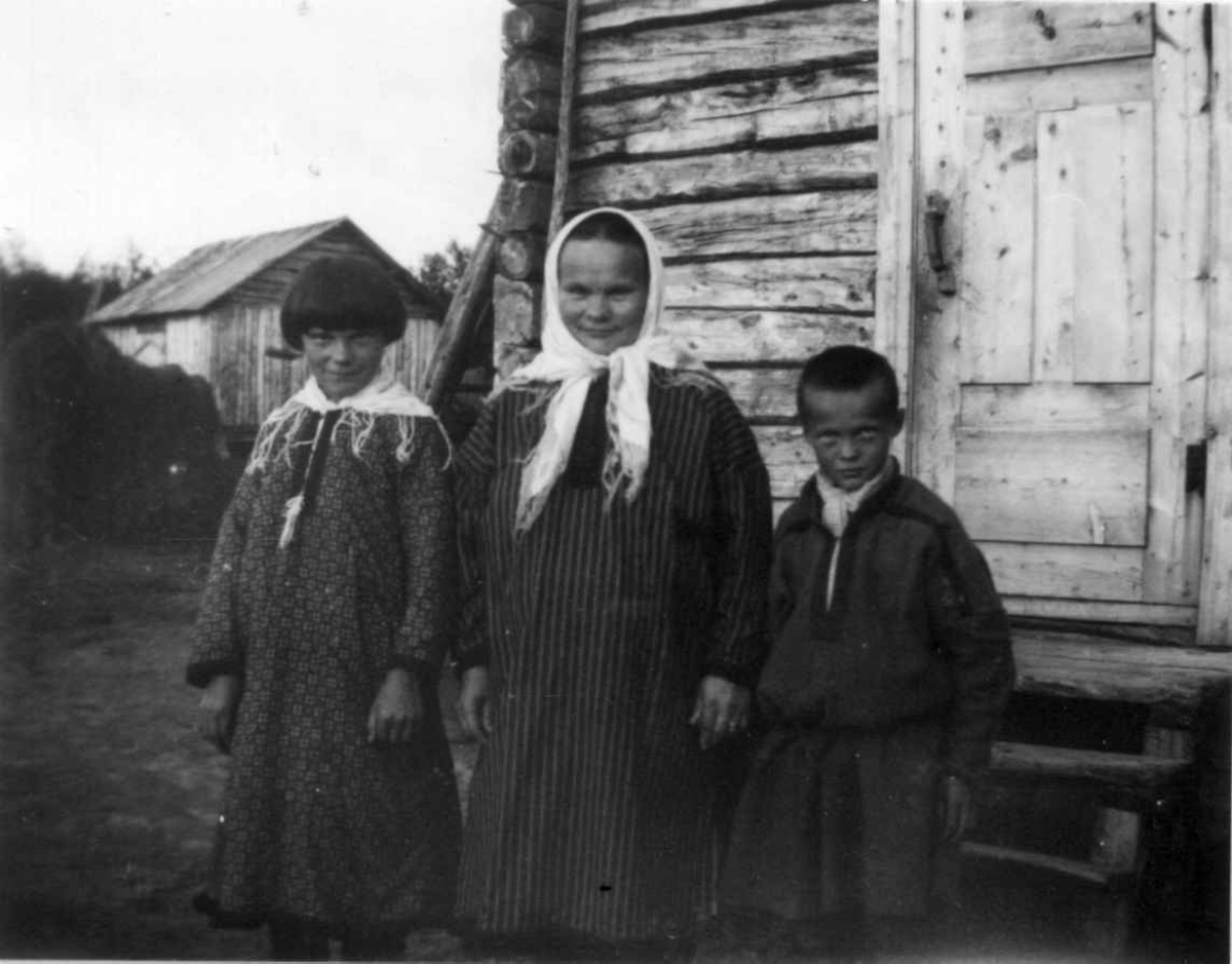 Samefamilie utenfor inngangspartiet til et hus, Buollamnjarga 1933.